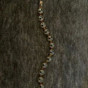 Henri Bendel bracelet. Gun metal Swarovski crystals incased in gold.